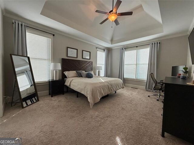 6863 Lake Sterling, Flowery Branch, GA 30542 - bedroom featuring a tray ceiling, carpet floors, ornamental molding, a desk, and ceiling fan