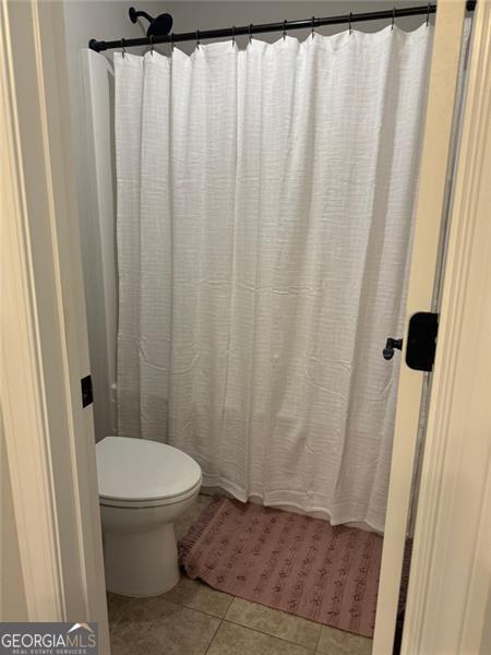 6863 Lake Sterling, Flowery Branch, GA 30542 - bathroom with tile patterned floors and a shower with shower curtain