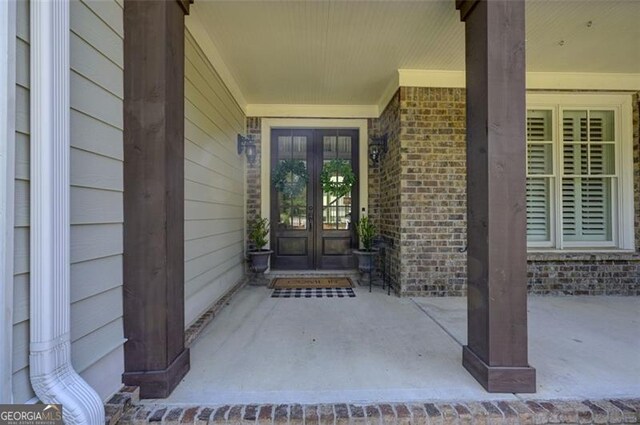 6863 Lake Sterling, Flowery Branch, GA 30542 - view of exterior entry featuring french doors and brick siding