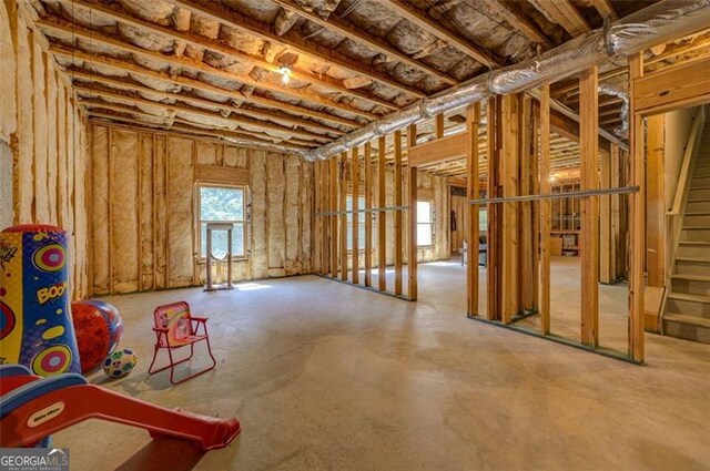 6863 Lake Sterling, Flowery Branch, GA 30542 - miscellaneous room featuring concrete flooring and stairway