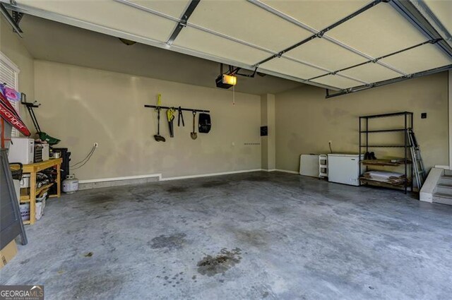 6863 Lake Sterling, Flowery Branch, GA 30542 - garage with fridge and a garage door opener