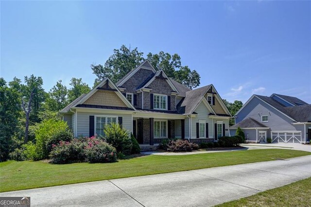 6863 Lake Sterling, Flowery Branch, GA 30542 - craftsman-style house featuring a front yard, driveway, and a garage