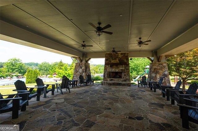 6863 Lake Sterling, Flowery Branch, GA 30542 - view of patio / terrace featuring an outdoor stone fireplace and ceiling fan