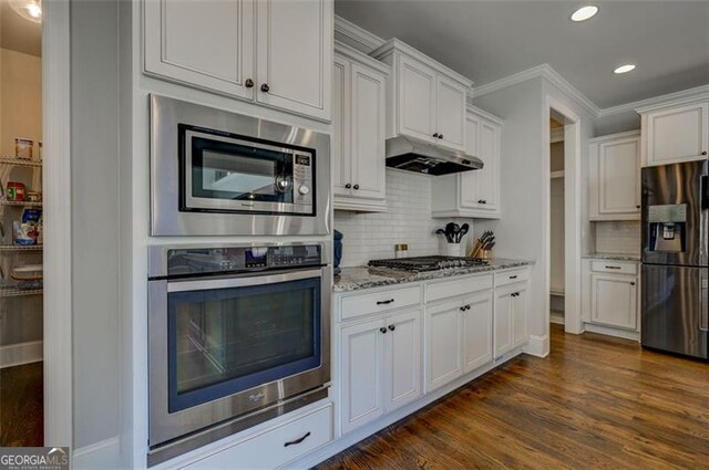 6863 Lake Sterling, Flowery Branch, GA 30542 - kitchen featuring stainless steel appliances, under cabinet range hood, light stone counters, recessed lighting, and tasteful backsplash