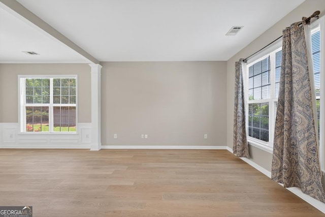 591 Wendlebury Ct, Alpharetta, GA 30004 - spare room featuring light wood-style floors, a wainscoted wall, and ornate columns