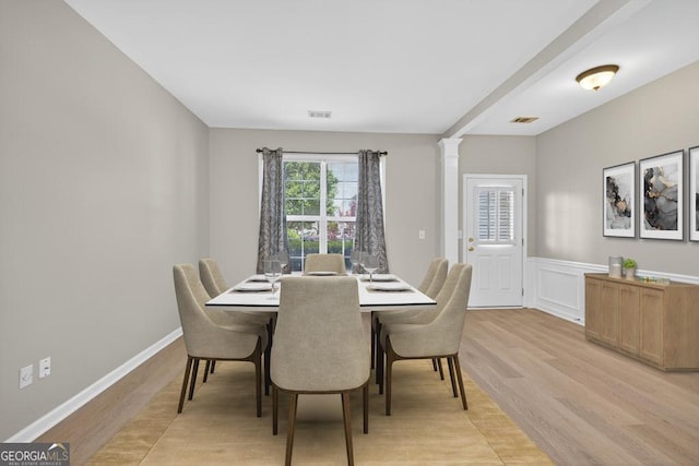 591 Wendlebury Ct, Alpharetta, GA 30004 - dining space featuring light wood finished floors, wainscoting, and ornate columns
