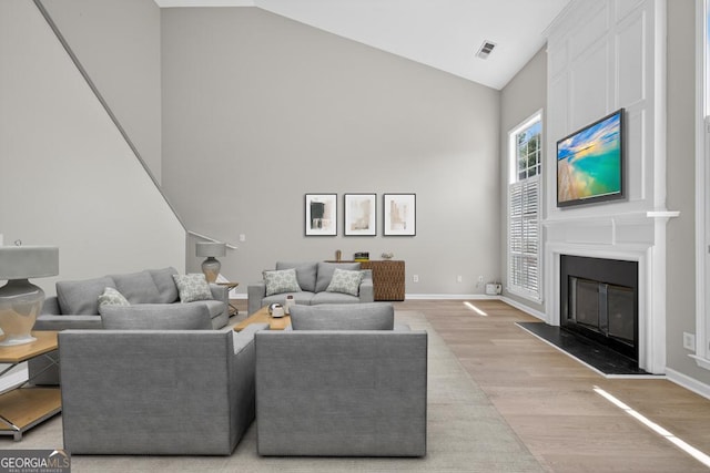 591 Wendlebury Ct, Alpharetta, GA 30004 - living area featuring high vaulted ceiling, light wood-style floors, and a fireplace