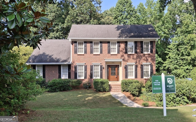 1131 Steeple Run, Lawrenceville, GA 30043 - colonial home featuring brick siding, a front lawn, and a shingled roof