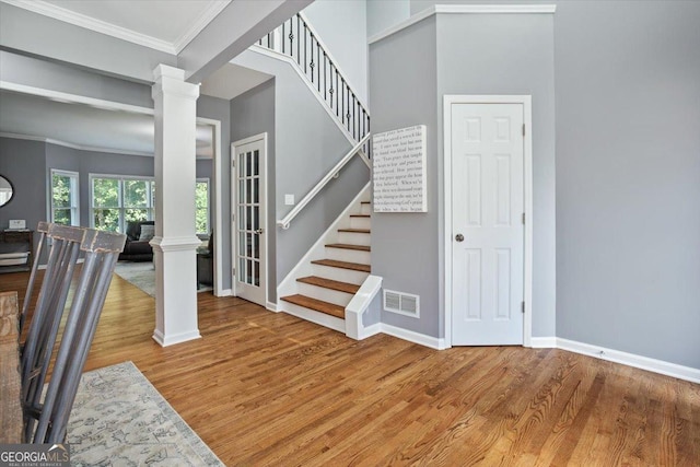 428 Gold Xing, Canton, GA 30114 - stairs with ornate columns, wood finished floors, and ornamental molding