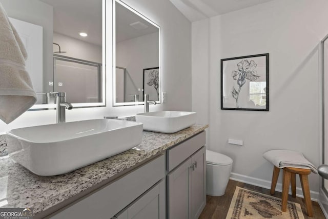 235 Ivey Ter, Temple, GA 30179 - bathroom featuring wood finished floors, double vanity, an enclosed shower, and recessed lighting