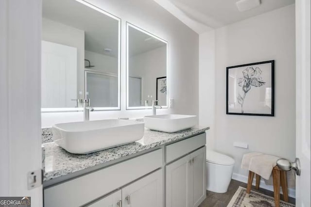 235 Ivey Ter, Temple, GA 30179 - full bath featuring double vanity, wood finished floors, and a shower with shower door