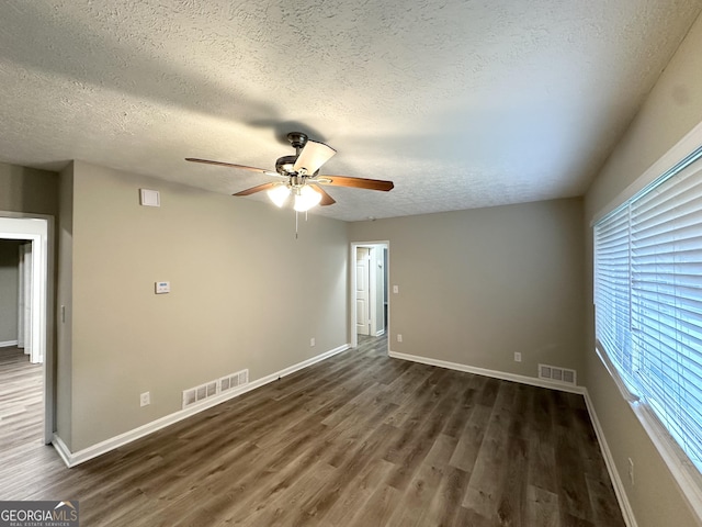 2644 Connally Dr, East Point, GA 30344 - spare room featuring a ceiling fan, dark wood finished floors, and a textured ceiling