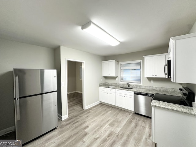 2644 Connally Dr, East Point, GA 30344 - kitchen featuring stainless steel appliances, light wood-style floors, white cabinets, and light stone countertops
