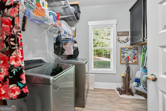 251 Spring Leaf Trl, Winterville, GA 30683 - washroom featuring washing machine and clothes dryer, cabinet space, and light wood-style floors