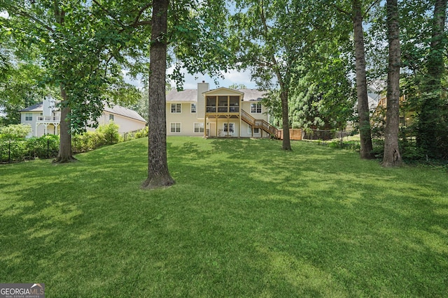 1535 Smoke Hill Dr, Hoschton, GA 30548 - back of property featuring a sunroom, a yard, stairway, and a chimney