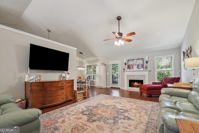 1535 Smoke Hill Dr, Hoschton, GA 30548 - living room featuring vaulted ceiling, dark wood-type flooring, ceiling fan, and a fireplace with flush hearth