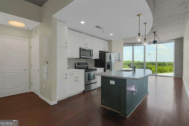 361 17th St Unit 910, Atlanta, GA 30363 - kitchen featuring stainless steel appliances, dark wood-style flooring, white cabinets, expansive windows, and recessed lighting
