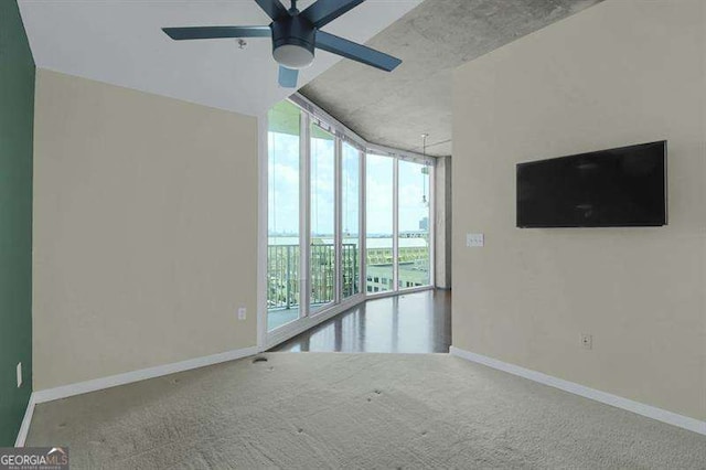 361 17th St Unit 910, Atlanta, GA 30363 - carpeted spare room featuring floor to ceiling windows and ceiling fan