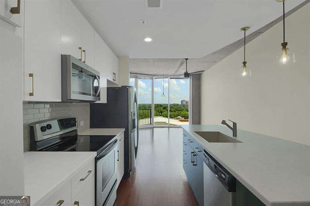361 17th St Unit 910, Atlanta, GA 30363 - kitchen featuring stainless steel appliances, white cabinets, dark wood-style floors, light countertops, and a wall of windows