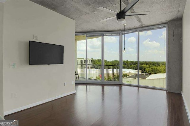 361 17th St Unit 910, Atlanta, GA 30363 - spare room featuring a wall of windows, ceiling fan, and wood finished floors
