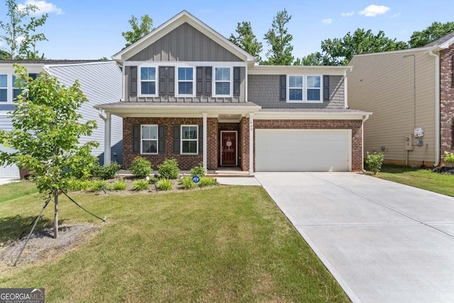 400 Paulownia Cir, Mcdonough, GA 30253 - view of front of home with board and batten siding, driveway, brick siding, a front yard, and a garage