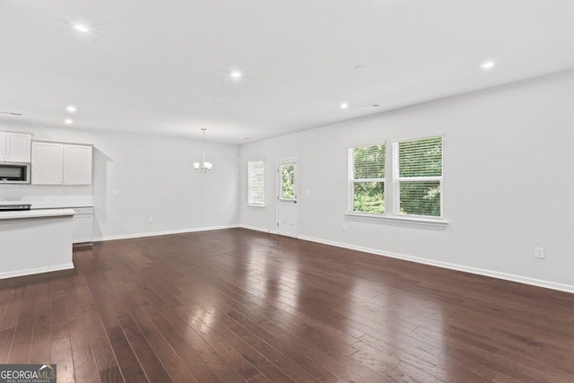 400 Paulownia Cir, Mcdonough, GA 30253 - unfurnished living room featuring a chandelier, recessed lighting, and dark wood finished floors