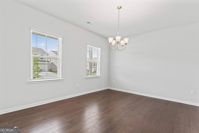 400 Paulownia Cir, Mcdonough, GA 30253 - empty room with a chandelier and dark wood finished floors