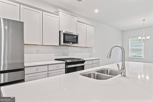 400 Paulownia Cir, Mcdonough, GA 30253 - kitchen with appliances with stainless steel finishes, light countertops, backsplash, hanging light fixtures, and recessed lighting