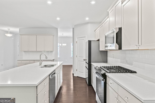 400 Paulownia Cir, Mcdonough, GA 30253 - kitchen featuring appliances with stainless steel finishes, dark wood-style flooring, tasteful backsplash, light countertops, and recessed lighting