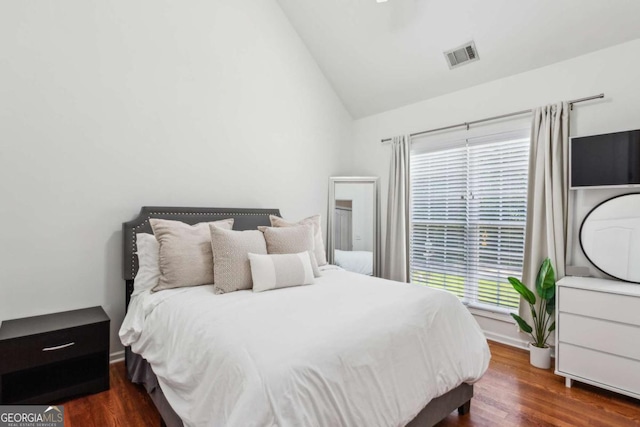 2140 Hurt Rd SW, Marietta, GA 30008 - bedroom with vaulted ceiling, multiple windows, and dark wood-style floors