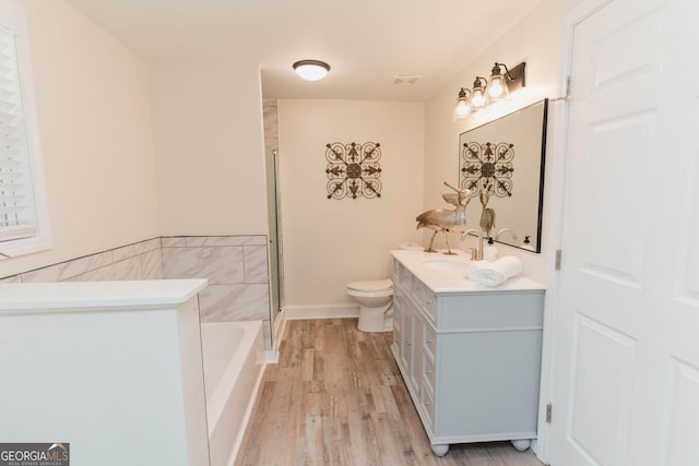 6914 N Baggett Rd, Douglasville, GA 30134 - bathroom featuring wood finished floors, vanity, a bath, and a shower with shower door