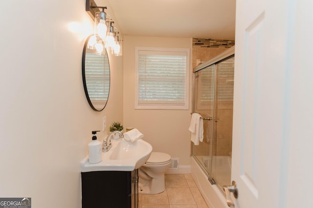 6914 N Baggett Rd, Douglasville, GA 30134 - bathroom with tile patterned floors, vanity, and bath / shower combo with glass door