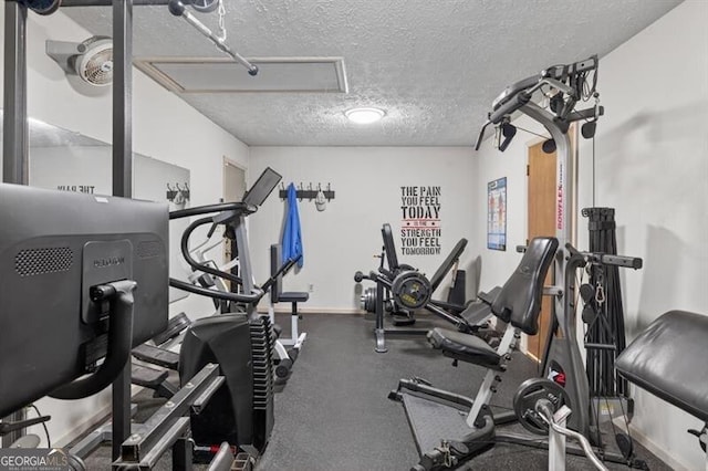 686 Hillwood Ct, Dacula, GA 30019 - exercise room with a textured ceiling and baseboards
