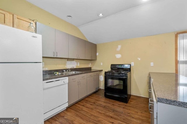 2030 Buford Dam Rd, Buford, GA 30518 - kitchen featuring white appliances, lofted ceiling, dark countertops, dark wood finished floors, and recessed lighting