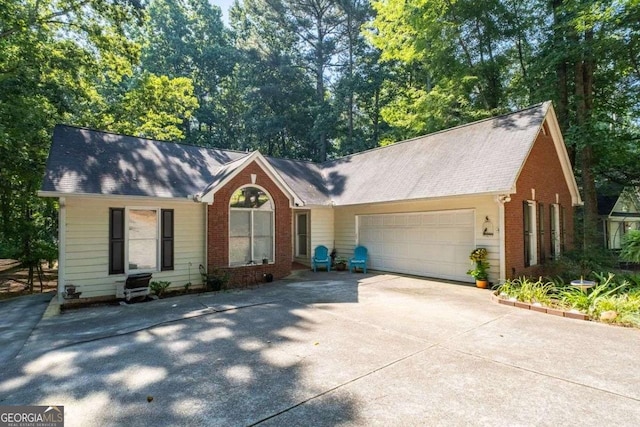 2030 Buford Dam Rd, Buford, GA 30518 - ranch-style home featuring an attached garage, brick siding, and driveway