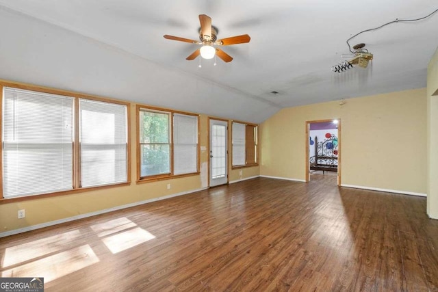2030 Buford Dam Rd, Buford, GA 30518 - unfurnished living room with lofted ceiling, wood finished floors, and ceiling fan
