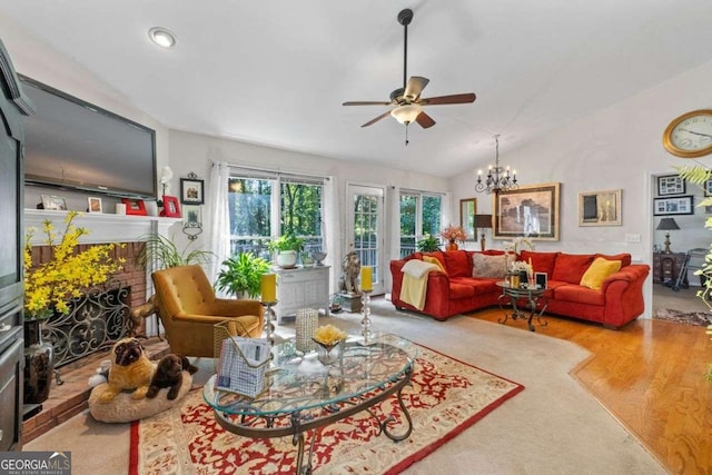 2030 Buford Dam Rd, Buford, GA 30518 - living area featuring ceiling fan, a brick fireplace, wood finished floors, vaulted ceiling, and a chandelier