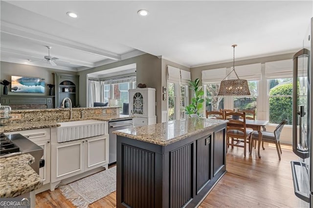 295 Sagamore Cv NW, Sugar Hill, GA 30518 - kitchen with stainless steel appliances, ornamental molding, light wood-style flooring, light stone countertops, and ceiling fan