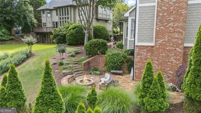 295 Sagamore Cv NW, Sugar Hill, GA 30518 - view of green lawn with a fire pit