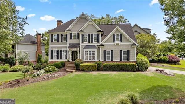 295 Sagamore Cv NW, Sugar Hill, GA 30518 - view of front of house featuring a chimney and a front lawn