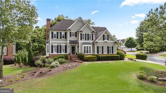 295 Sagamore Cv NW, Sugar Hill, GA 30518 - view of front of property featuring a front lawn and a chimney