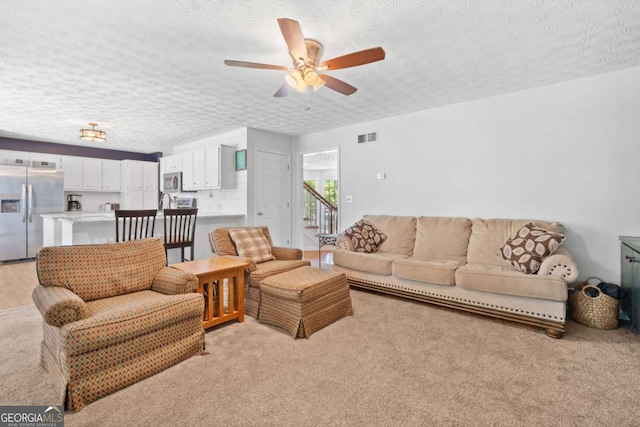 5055 Southland Dr, Woodstock, GA 30188 - living area featuring a textured ceiling, light colored carpet, and ceiling fan