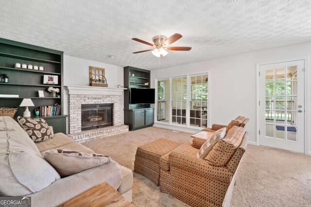 5055 Southland Dr, Woodstock, GA 30188 - living room featuring carpet, a ceiling fan, plenty of natural light, and a textured ceiling