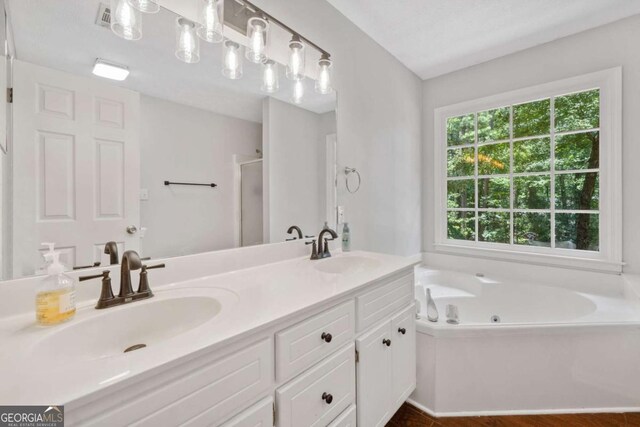 5055 Southland Dr, Woodstock, GA 30188 - bathroom with a jetted tub, double vanity, and a stall shower