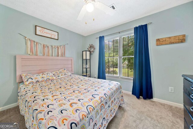 5055 Southland Dr, Woodstock, GA 30188 - carpeted bedroom featuring ceiling fan and a textured ceiling