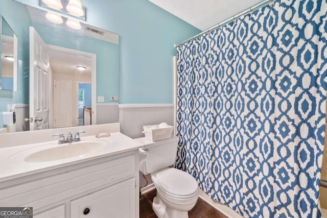 5055 Southland Dr, Woodstock, GA 30188 - full bathroom featuring vanity, wainscoting, a shower with curtain, and wood finished floors