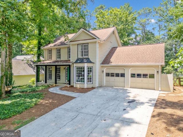 5055 Southland Dr, Woodstock, GA 30188 - traditional-style home featuring a garage, driveway, a porch, and roof with shingles