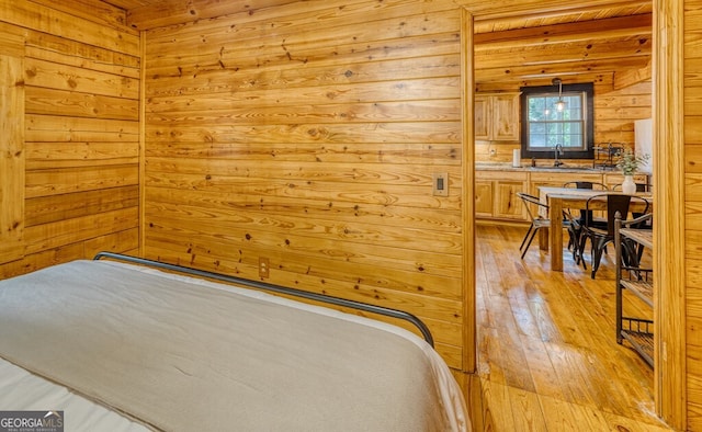 371 Abbott Top Rd, Ellijay, GA 30540 - bedroom featuring wooden walls, light wood-type flooring, and wooden ceiling