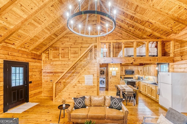371 Abbott Top Rd, Ellijay, GA 30540 - living room featuring wooden walls, high vaulted ceiling, a wooden ceiling with exposed beams, a chandelier, and light wood-style flooring