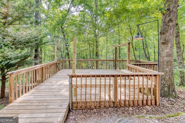 371 Abbott Top Rd, Ellijay, GA 30540 - wooden terrace with a wooded view